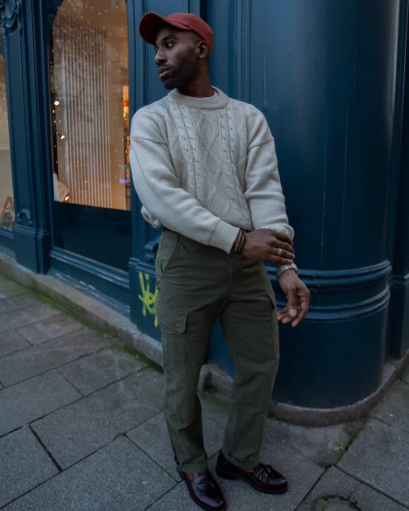 stylish man wearing a fisherman sweater with green cargo pants