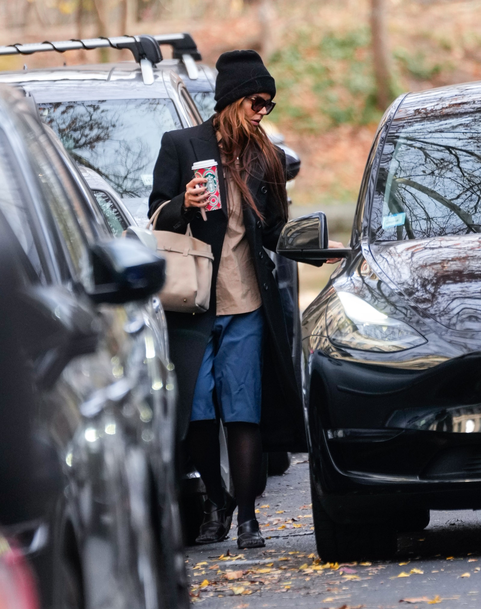 Image may contain Katie Holmes Accessories Bag Handbag Clothing Footwear Shoe Hat Adult Person and Car