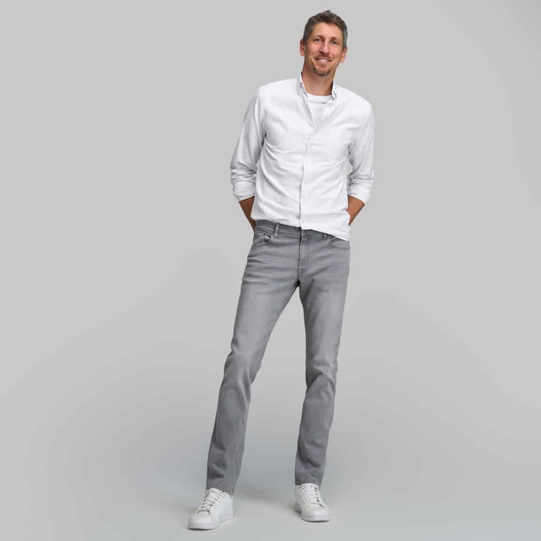 man in a white shirt and gray jeans