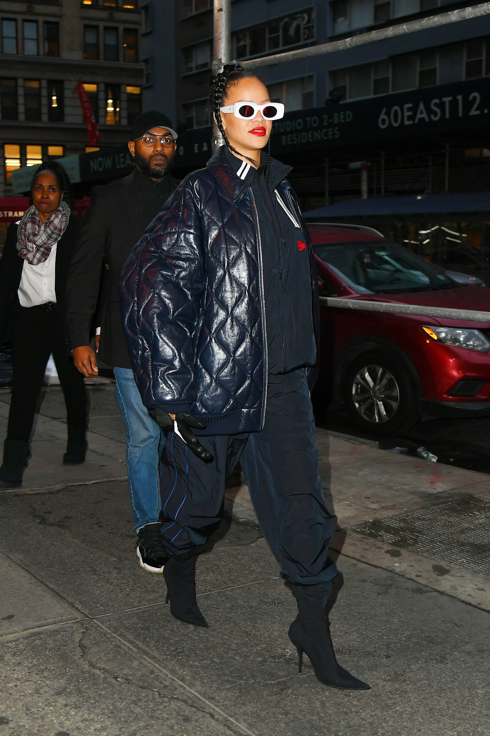 Image may contain Rihanna Liz McComb Clothing Coat Jacket Footwear Shoe Accessories Glasses Adult Person and Hat