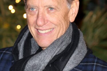 Image may contain Richard E. Grant Face Head Person Photography Portrait Adult Happy Smile Clothing and Scarf