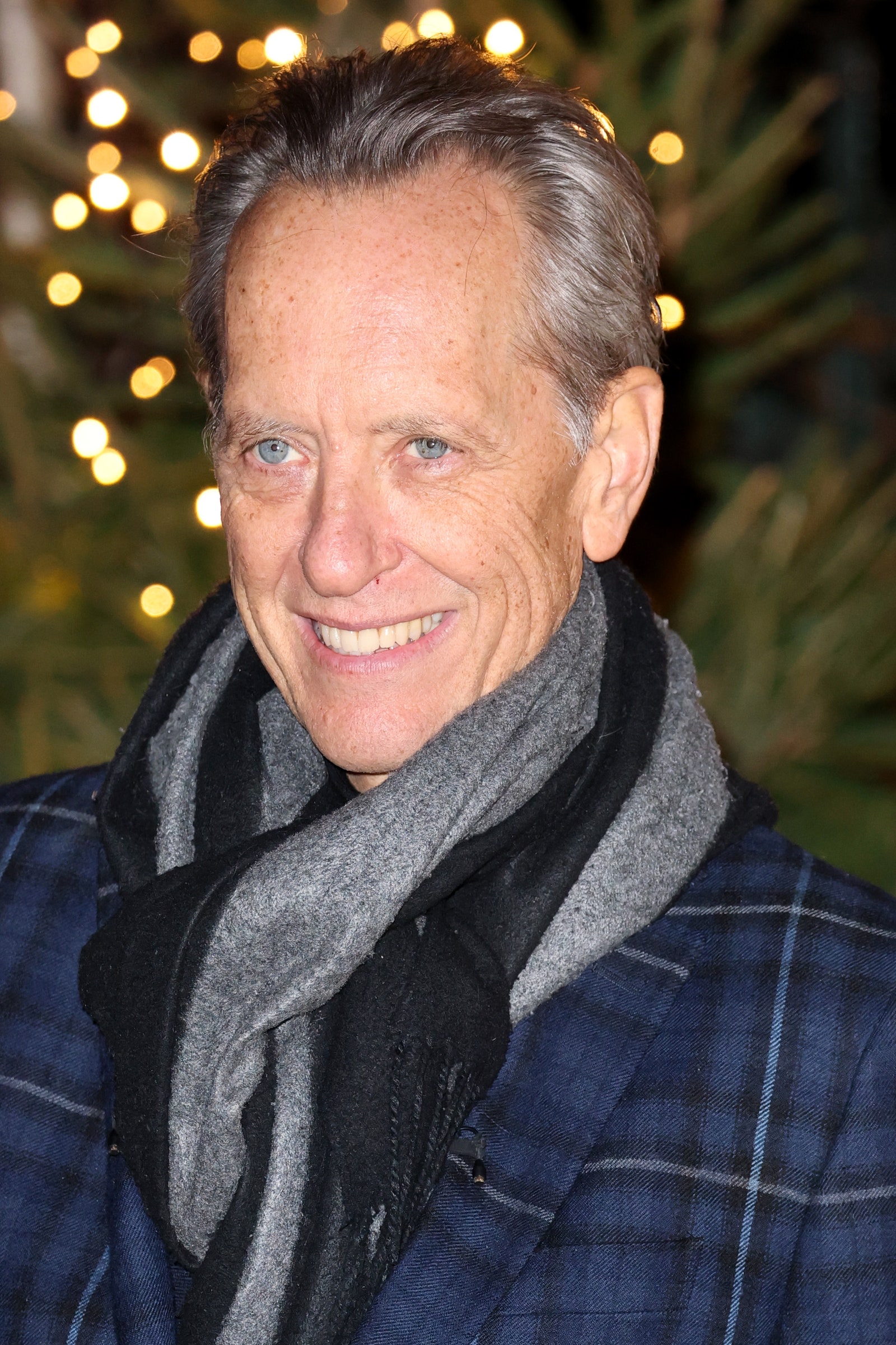 Image may contain Richard E. Grant Face Head Person Photography Portrait Adult Happy Smile Clothing and Scarf