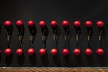 A row of gigantic hair ties with red balls