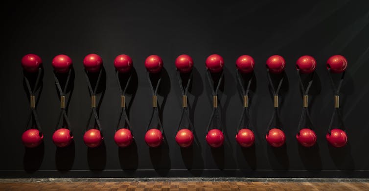 A row of gigantic hair ties with red balls