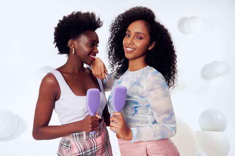 Two women with hairbrushes