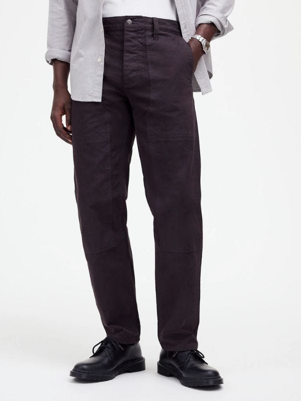 man from the waist down wearing dark workwear pants