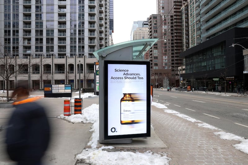 On the side of a bus stop in downtown Toronto, the skincare brand The Ordinary has run an ad for its new growth factor serum, with the text "Science advances. Access should too."