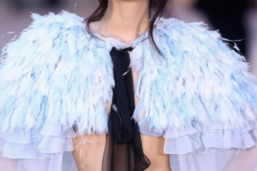 Jennie wearing a light blue feathery cape
