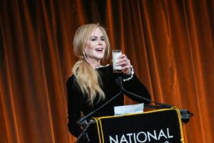 Image may contain Nicole Kidman Crowd Person Adult Audience Electrical Device Microphone Beverage Milk and Speech