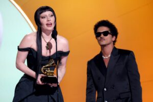 Image may contain Lady Gaga Bruno Mars Adult Person Accessories Jewelry Necklace Glasses Black Hair Hair and Face