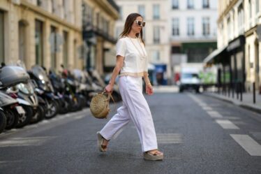 PARIS FRANCE  MAY 10 Maria Rosaria Rizzo wears white sunglasses a white pearls long necklace a white latte tshirt with...