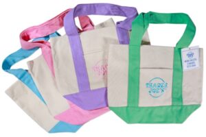 Mini canvas tote bags in pastel blue, pink, purple and green available at Trader Joe's