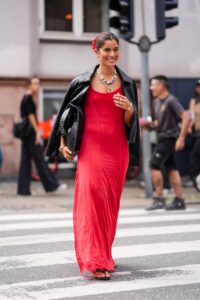 COPENHAGEN DENMARK  AUGUST 8 A guest wears red scrunchie gold earrings gold bracelets gold rings white layered beaded...