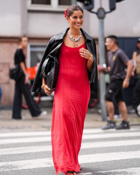 COPENHAGEN DENMARK  AUGUST 8 A guest wears red scrunchie gold earrings gold bracelets gold rings white layered beaded...