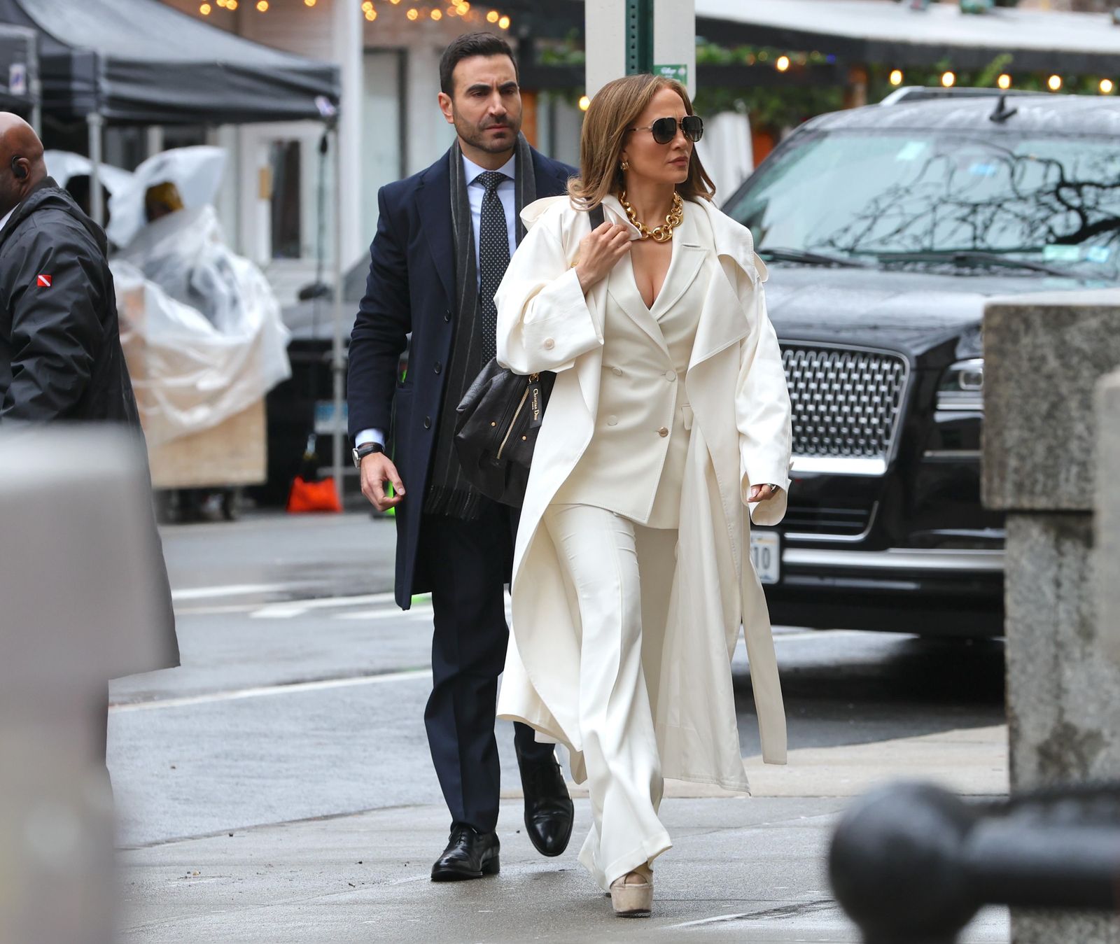 Image may contain Brett Goldstein Jennifer Lopez Pedestrian Person Adult Accessories Bag Handbag Clothing and Coat