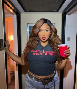 Image may contain Lizzo Brown Hair Hair Person Cup Disposable Cup and Teen