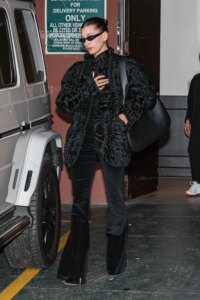 Image may contain Hailey Baldwin Clothing Pants Accessories Bag Handbag Adult Person Coat Car and Transportation